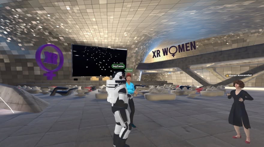Avatars in the XR Women auditorium with a shimmering tiled dome